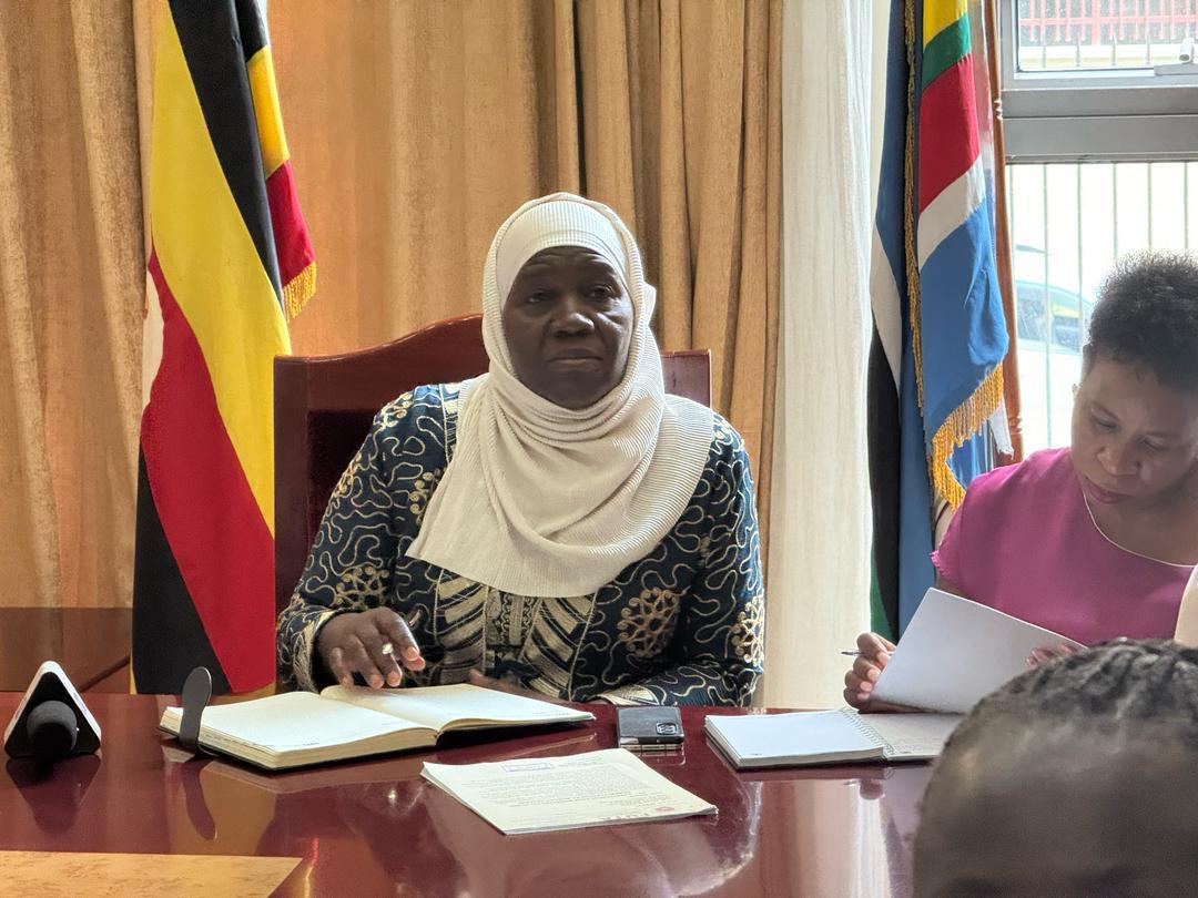 A government meeting under the Uganda flag, where FUTA takes traders’ concerns